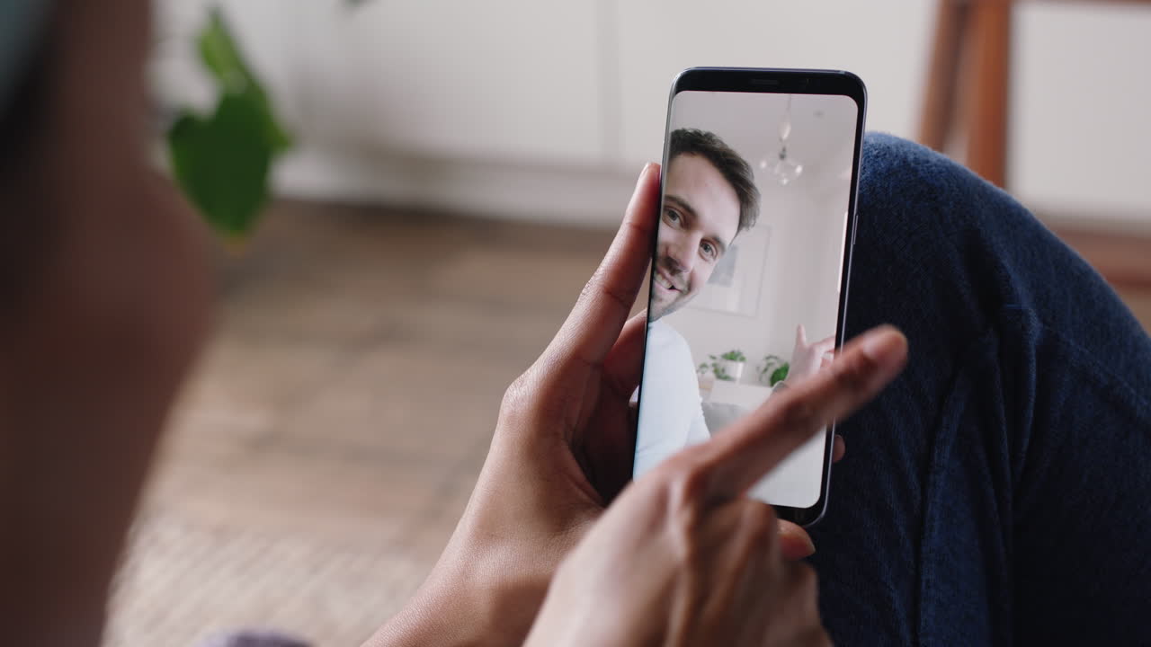 mujer joven teniendo video chat usando teléfono inteligente en casa hablando con su novio mostrando el estilo de vida de compartir apartamento disfrutando de una relación a larga distancia