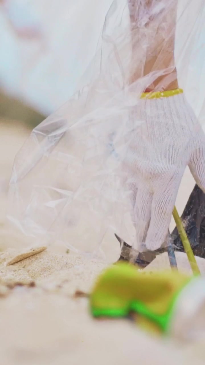 People picking up litter in an outdoor cleanup scene with plastic debris today