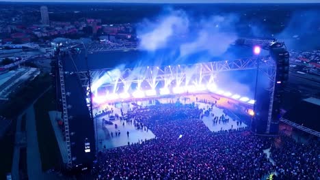 aerial view of a large crowd at a concert with stage lights