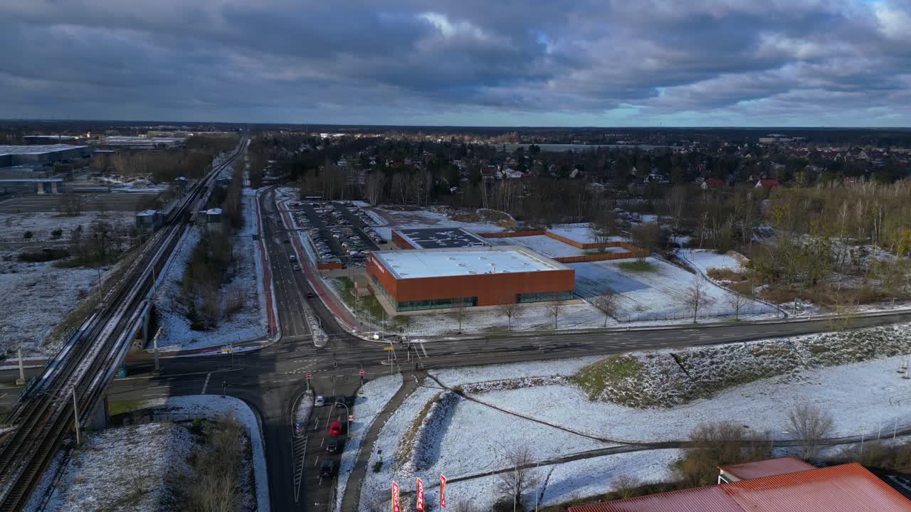 Indoor swimming pool with solar panels surrounded by snow and suburban homes in Falkensee Germany. Marvelous aerial view flight static tripod hovering drone