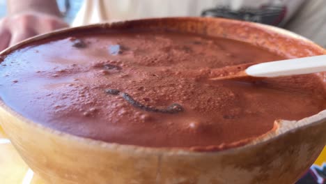 close up of cup of pozol traditional drink beverage energetic with ice made in chiapas mexico