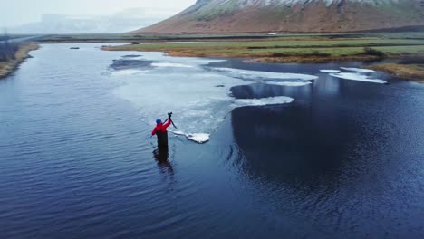 Photographer-installing-tripod-in-river