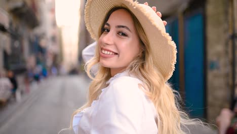 slow,motion:attractive young beautiful girl pulls arm of her boyfriend at narrow street in europe