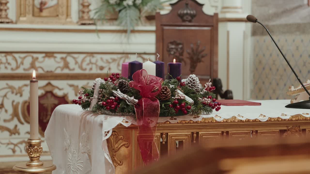 Christmas advent wreath with candles placed on decorated church altar