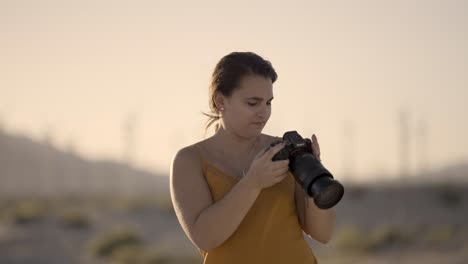 girl photographing palm springs area desert california with a sony a1 camera reviewing photos