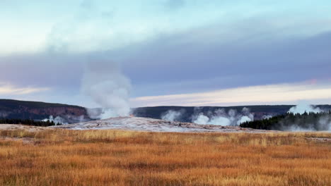 west yellowstone old faithful national park entrance grand loop geysers scenic landscape wyoming idaho mist steam thermal grand prismatic colorful yellow sunset tall grass cinematic slowly pan left