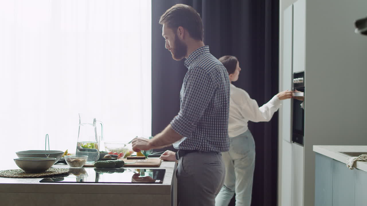 pareja preparando comida en una cocina de estilo moderno