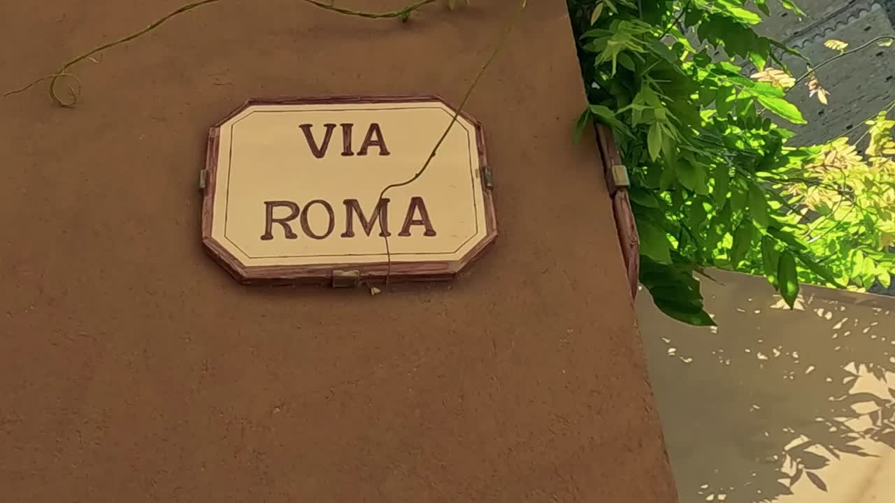 A glimpse of Via Roma's rustic walls and narrow alleyway, showcasing traditional Italian architecture.