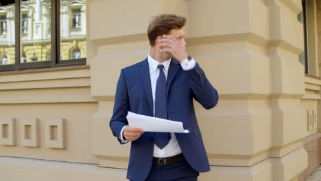 portrait of successful business man working with documents outdoors.