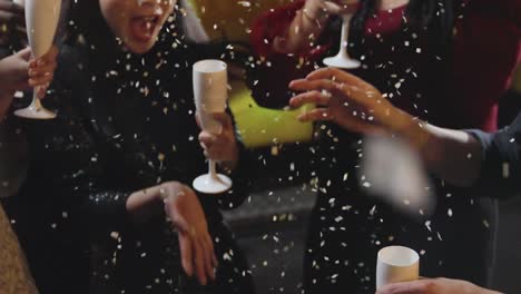 Close-Up-of-Friends-Celebrating-New-Years-Eve-with-Confetti