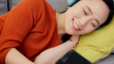 Phone,-headphones-and-woman-streaming-movie