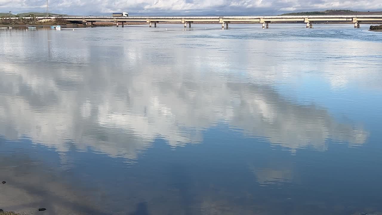 wide view of a calm river with a beautiful blue sky
