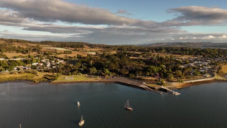 Aerial-approaching-shot-of-port-at-Tamar-River-during-sunset-time