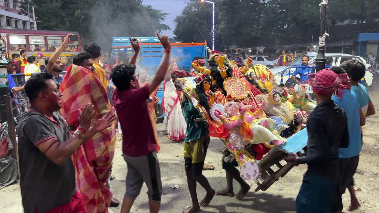 HIndu rituals of rotating the idol for seven items before immersion of it into river in Kolkata, India. Scenes of Vijay Dashami.