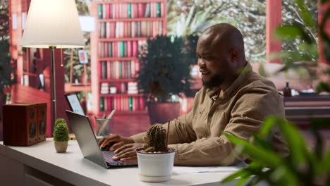 successful freelancer using his laptop for remote business tasks