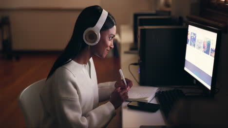 Business,-headphones-and-woman-writing
