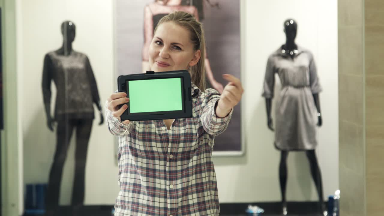 The Girl Shows The Tablet With The Green Screen