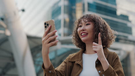 young woman video chatting in the city