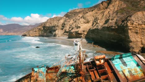 Aerial-Shot-of-a-Dusty-Ship-in-the-Pacific-Ocean-in-the-Summer-with-a-Happy-Bird-on-the-Top