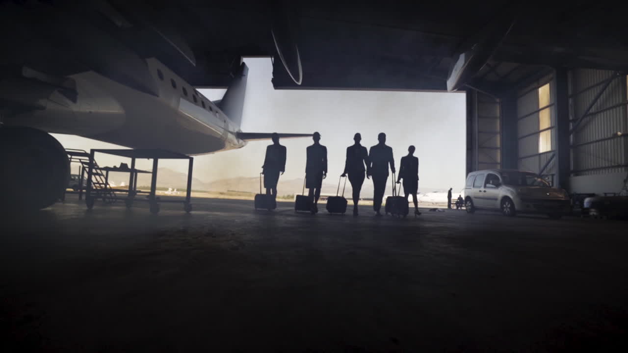 Group of travelers walking towards airplane
