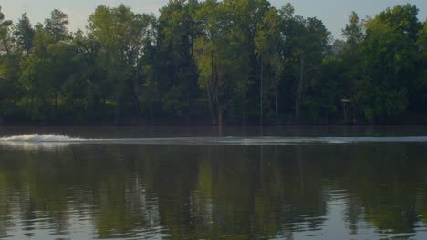 Boat going upstream a river in the morning