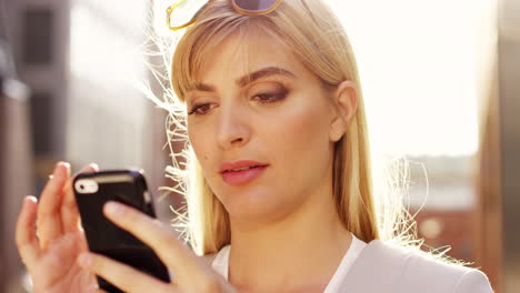 businesswoman using smartphone outdoors