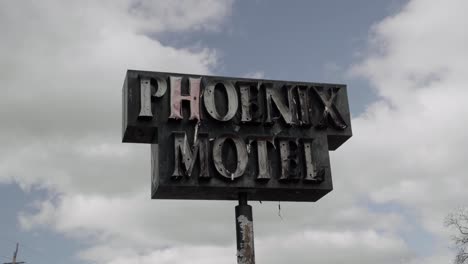 burnt sign that says "phoenix motel" - aftermath of southern oregon 2020 wildfires - 4k