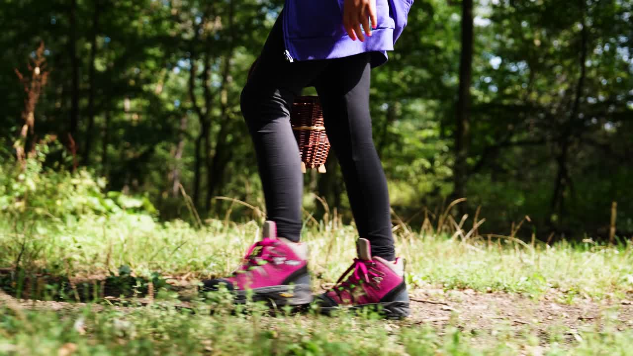 Girl wear pink boots and black leggings walk in countryside forest, Czechia