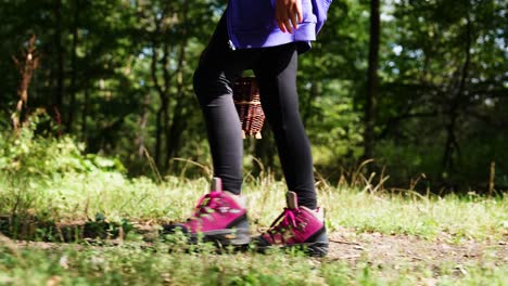 girl wear pink boots and black leggings walk in countryside forest, czechia