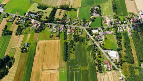 aerial view of green fields and sun in the sky