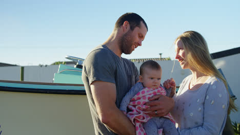 Parents-holding-baby-boy-at-backyard-4k