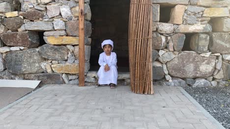 arab kid in arabian traditional house made with stone