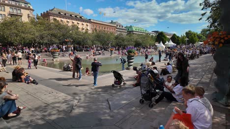 crowded people relaxing in kungstradgarden park in central stockholm, sweden. slow motion shot