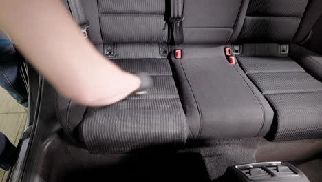 unrecognizable person wiping passenger seats