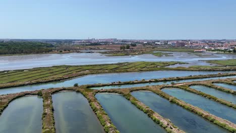 drone shot flying over a line of artificial ponds