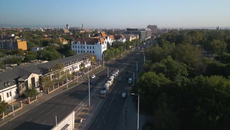 Drone-Flies-Above-Yellow-Tram-Car-in-Budapest,-Hungary---Public-Transit