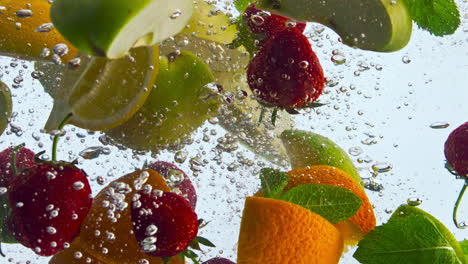 closeup fruit submerged water on white background. vitamin for healthy nutrition