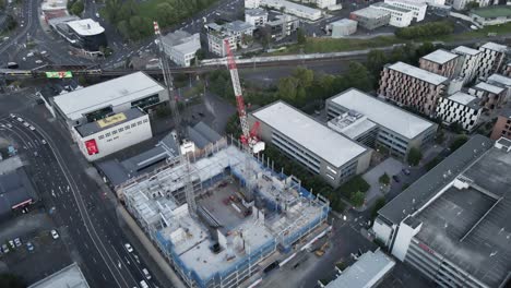 buildings with cranes under construction downtown new zealand at daytime, orbital aerial