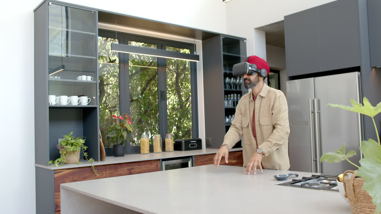 Using VR headset, man exploring virtual reality in modern kitchen at home