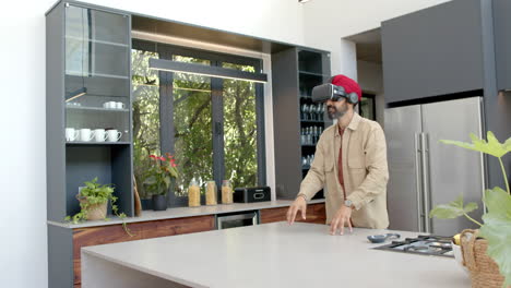 using vr headset, man exploring virtual reality in modern kitchen at home