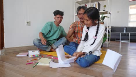 asian little girl throws paper makes father and brother annoyed