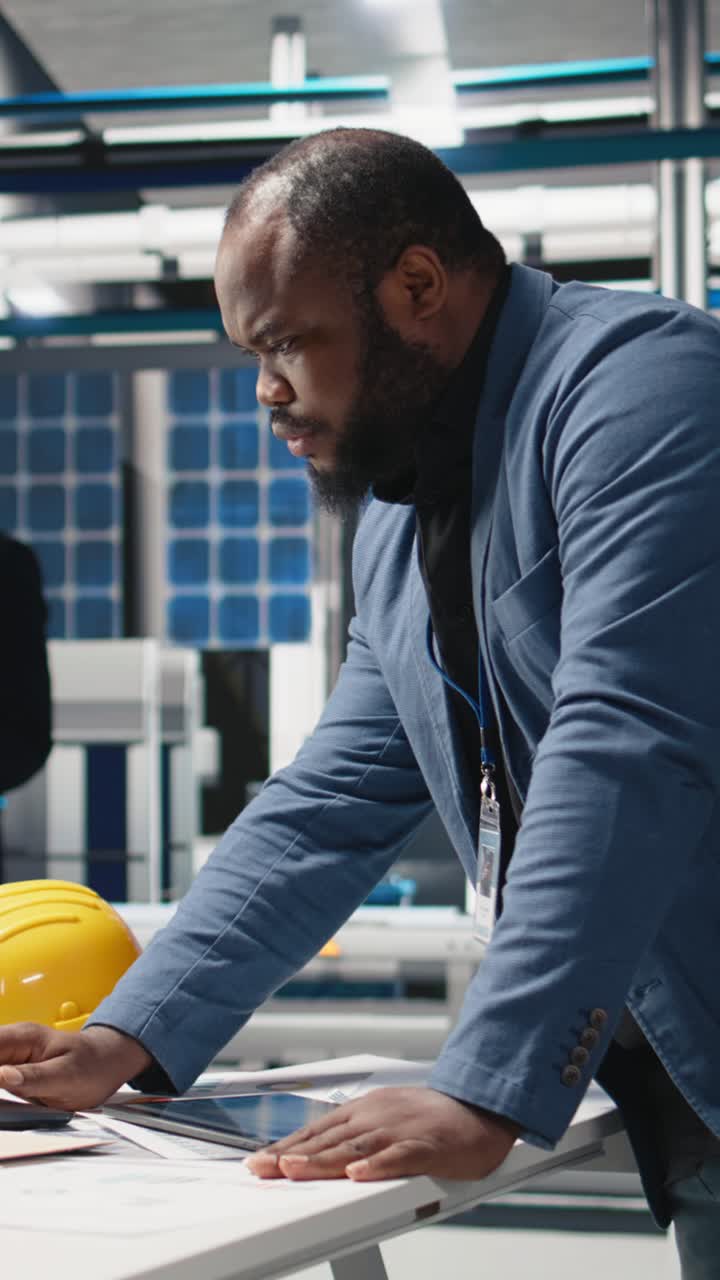 Vertical Video African american industry expert reviewing photovoltaics assembly line