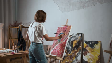 young woman painting a canvas