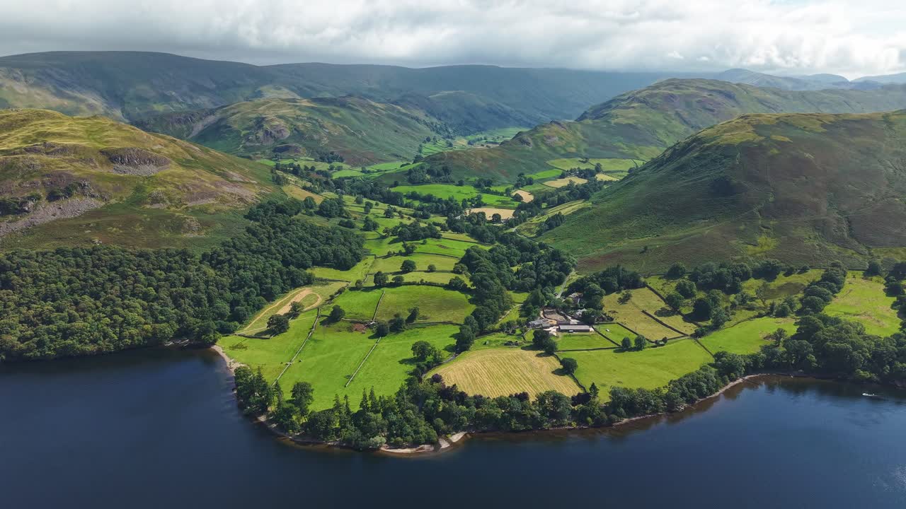 Rotating aerial drone view of Sandwick hamlet on the shores of Ullswater in the Lake District