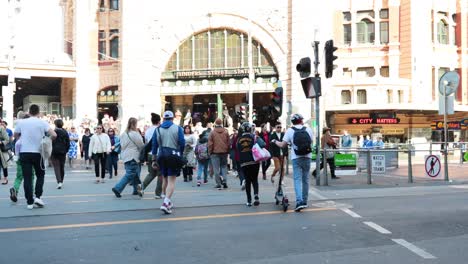 crowd crossing street in busy melbourne morning