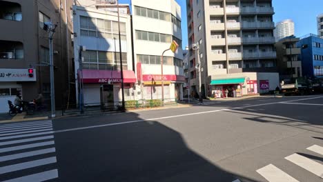 vehicles and cyclist moving through city crosswalk