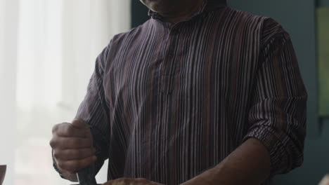 a man preparing food with mortar and pestle