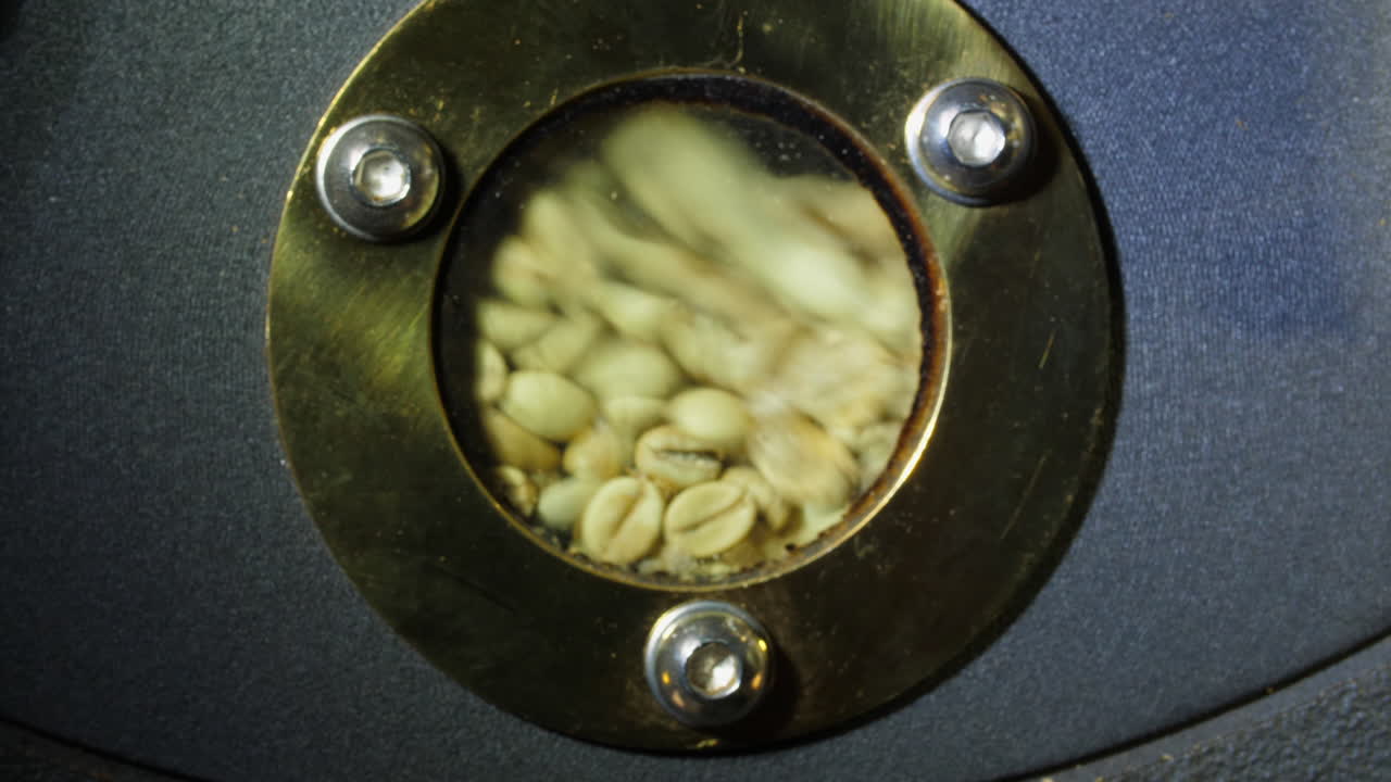 Raw Coffee Beans In Modern Machine With Roaster