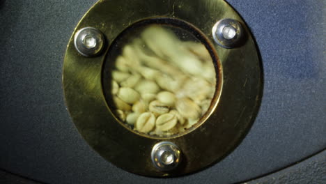 raw coffee beans in modern machine with roaster