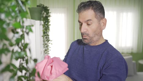 Mature-man-cleaning-his-house-cleans-things-from-dust-and-dirt.